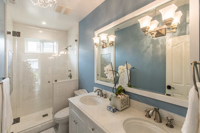 Inspiration for a mid-sized timeless kids' white tile and subway tile alcove shower remodel in San Francisco with white cabinets, a one-piece toilet, blue walls, an undermount sink, shaker cabinets and quartz countertops