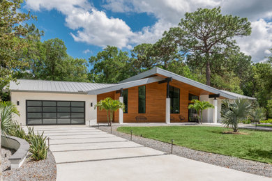 Photo of a modern white house exterior in Orlando with a grey roof.