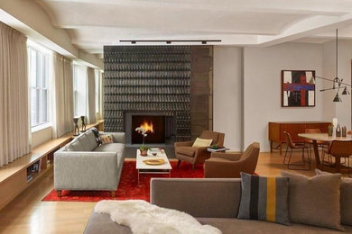 Inspiration for a mid-sized contemporary formal and open concept light wood floor and brown floor living room remodel in New York with beige walls, a standard fireplace, a stone fireplace and no tv