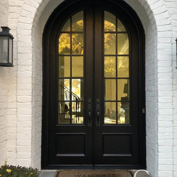 Arched Iron Doors with Bright Custom Windows