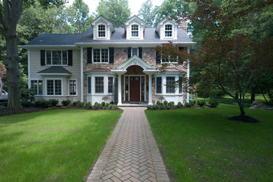 Example of a mid-sized classic beige two-story mixed siding house exterior design in New York with a hip roof and a shingle roof