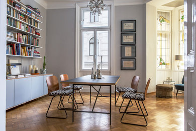 Dining room - mid-sized eclectic light wood floor dining room idea in Other with gray walls