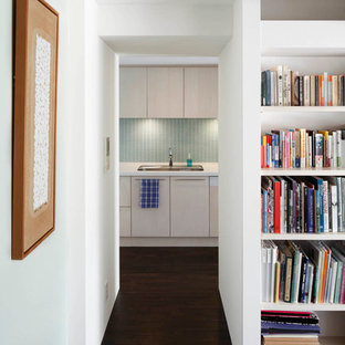 Mid-sized contemporary kitchen pantry pictures - Kitchen pantry - mid-sized contemporary galley dark wood floor kitchen pantry idea in Tokyo with an undermount sink, flat-panel cabinets, light wood cabinets, solid surface countertops, blue backsplash, glass tile backsplash, paneled appliances and no island