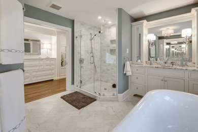 Example of a large classic master multicolored tile and marble tile marble floor and gray floor bathroom design in Philadelphia with flat-panel cabinets, white cabinets, a one-piece toilet, gray walls, an undermount sink, marble countertops and a hinged shower door