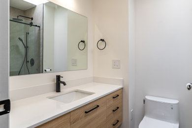 Mid-sized minimalist single-sink bathroom photo in Vancouver with flat-panel cabinets, light wood cabinets, quartzite countertops, white countertops and a floating vanity