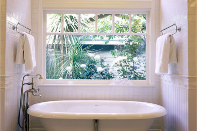 Inspiration for a large transitional master white tile and subway tile mosaic tile floor and white floor freestanding bathtub remodel in Los Angeles with white walls