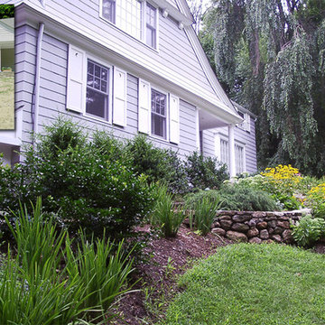Terrace plantings minimize steep front yard drop. Perennials add color and textu