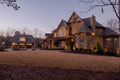 Inspiration for a large craftsman brown three-story brick exterior home remodel in Raleigh with a hip roof