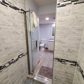 Finished basement custom shower with Kohler glass door