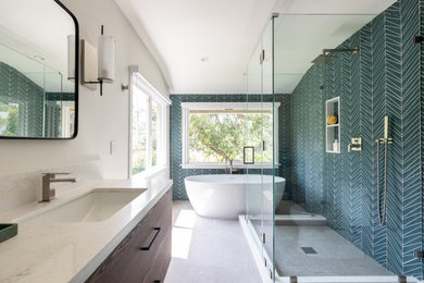 Large trendy master green tile and glass tile gray floor and double-sink bathroom photo in Los Angeles with flat-panel cabinets, dark wood cabinets, a one-piece toilet, white walls, an undermount sink, quartz countertops, a hinged shower door, white countertops and a floating vanity