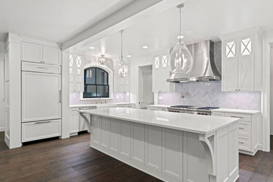 Example of a classic u-shaped eat-in kitchen design in Portland with shaker cabinets, white cabinets, quartzite countertops, an island and white countertops