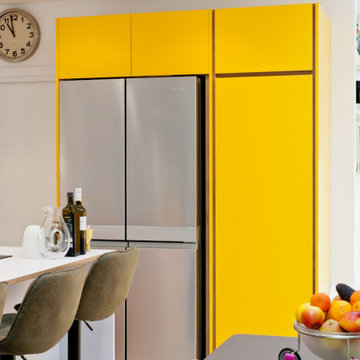 Large white plywood kitchen with yellow accents