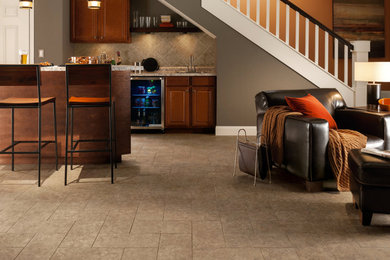 Large trendy single-wall seated home bar photo in Other with a drop-in sink, raised-panel cabinets, dark wood cabinets, laminate countertops and gray backsplash