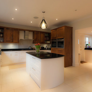 Large contemporary kitchen pantry designs - Large trendy u-shaped porcelain floor kitchen pantry photo in Kent with a farmhouse sink, shaker cabinets, white cabinets, granite countertops, stainless steel appliances and an island