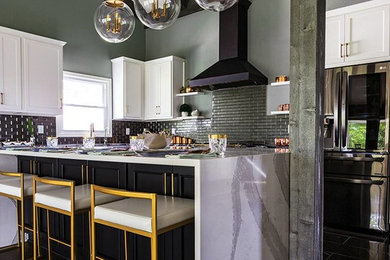 This is an example of a mid-sized transitional l-shaped eat-in kitchen in Kansas City with an undermount sink, shaker cabinets, white cabinets, quartz benchtops, metallic splashback, glass tile splashback, stainless steel appliances, porcelain floors, with island, black floor and grey benchtop.