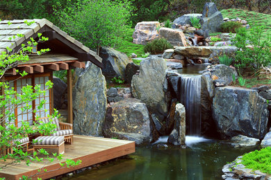 Design ideas for an asian garden in Denver with decking and with waterfall.