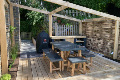 Medium sized farmhouse back full sun pergola for summer in Other with decking and a wood fence.