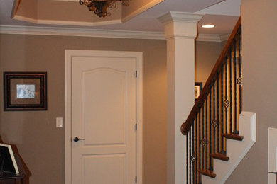 This is an example of a large traditional walk-out basement in Atlanta with beige walls, dark hardwood floors and a wood stove.