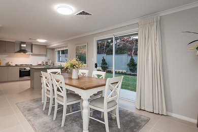 This is an example of a large country open plan dining in Perth with grey walls, porcelain floors and grey floor.