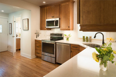 Mid-sized transitional light wood floor enclosed kitchen photo in Chicago with an undermount sink, shaker cabinets, medium tone wood cabinets, quartz countertops, multicolored backsplash, glass sheet backsplash, stainless steel appliances and no island