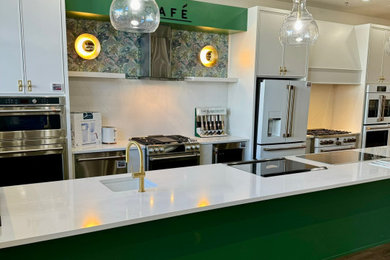 Example of a minimalist kitchen design with white cabinets and an island