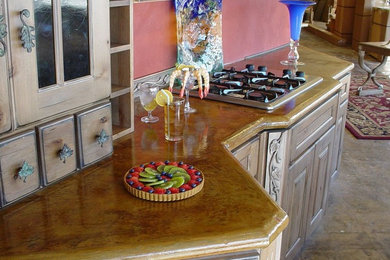 Example of a mid-sized classic concrete floor open concept kitchen design in Oklahoma City with concrete countertops, pink backsplash and an island