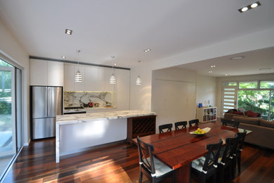 Inspiration for a large contemporary open plan dining in Sydney with white walls and medium hardwood floors.