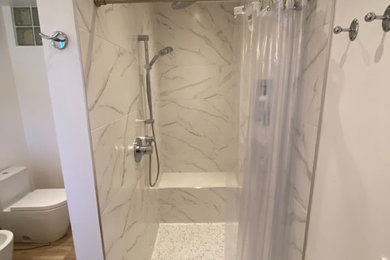 Inspiration for a mid-sized master white tile and ceramic tile wood-look tile floor, brown floor and single-sink bathroom remodel in San Diego with a bidet, white walls, an undermount sink, quartzite countertops, white countertops and a built-in vanity