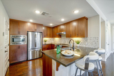 Eat-in kitchen - small transitional u-shaped medium tone wood floor eat-in kitchen idea in San Francisco with an undermount sink, shaker cabinets, medium tone wood cabinets, quartzite countertops, multicolored backsplash, mosaic tile backsplash, stainless steel appliances, a peninsula and gray countertops