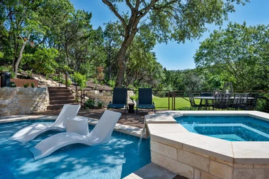 Inspiration for a large backyard brick and l-shaped aboveground pool landscaping remodel in Other