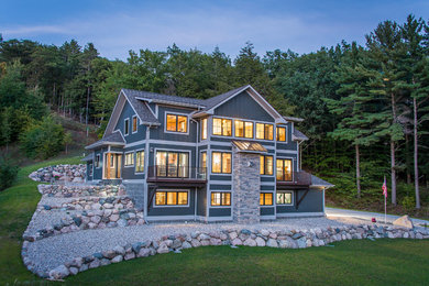 Large contemporary green three-story wood exterior home idea in Other with a shingle roof