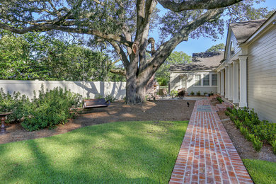 Example of a mid-sized classic backyard brick patio design in Other with a fire pit