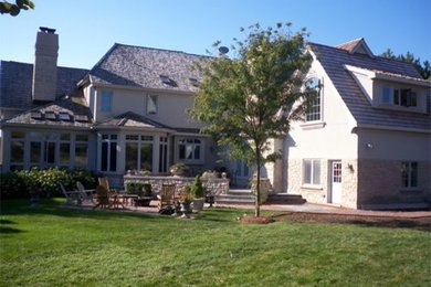 Inspiration for a large timeless white two-story wood exterior home remodel in Chicago