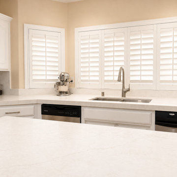 White Quartz Kitchen with Navy Island and Plantation Shutters