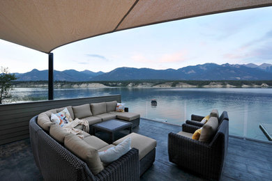 Inspiration for a mid-sized contemporary rooftop deck remodel in Vancouver with an awning