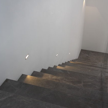 Modern gray marble stairs with crossing glass
