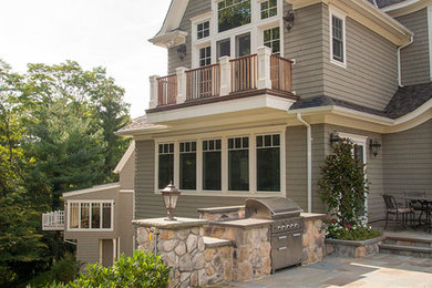 Photo of a large traditional two-storey grey exterior in New York with wood siding.