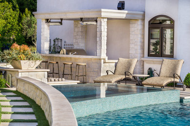 Inspiration for a mediterranean home bar remodel in Orange County