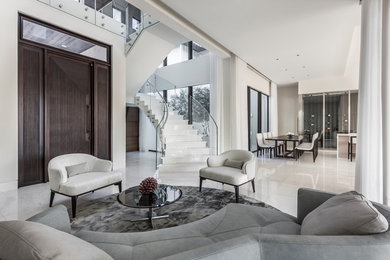 Photo of a contemporary open concept living room in Miami with white walls and white floor.