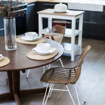 Rattan Paperclip Leg Dining Chairs with Vintage Dining Table in Open Plan Kitche