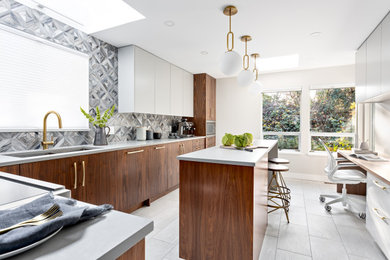 Example of a mid-sized trendy u-shaped porcelain tile and gray floor enclosed kitchen design in Vancouver with an undermount sink, flat-panel cabinets, medium tone wood cabinets, quartz countertops, multicolored backsplash, glass tile backsplash, stainless steel appliances, an island and white countertops