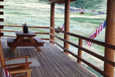 Mountain style side porch photo in Other with decking and a roof extension