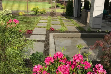 Design ideas for a mid-sized contemporary partial sun backyard concrete paver garden path in Boise for summer.
