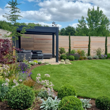 Contemporary Cedar Slatted Fence in pretty modern planted garden