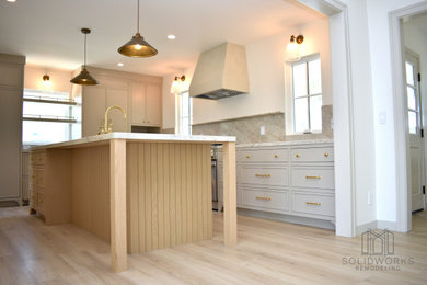 Eat-in kitchen - contemporary light wood floor and beige floor eat-in kitchen idea in Los Angeles with a drop-in sink, stainless steel appliances and an island