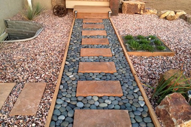 Design ideas for a mid-sized southwestern drought-tolerant and full sun backyard gravel garden path in Other for summer.