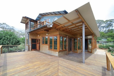 Inspiration for a mid-sized contemporary two-storey exterior in Sydney with wood siding.