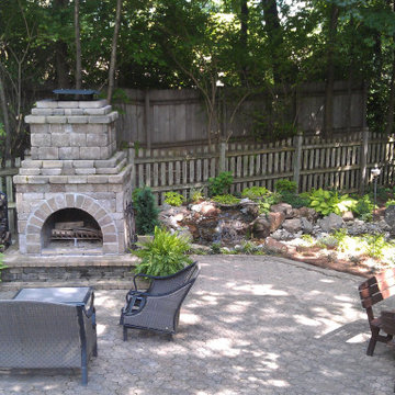 Shady Backyard with Waterfall, Stream, Fireplace and Landscape
