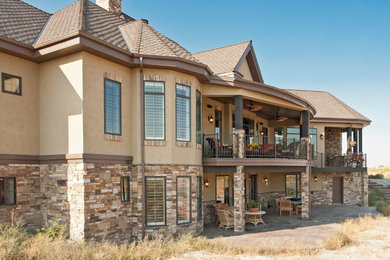 Inspiration for a large transitional beige two-story mixed siding house exterior remodel in Other with a hip roof and a shingle roof