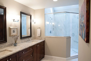 Inspiration for a mid-sized country master ceramic tile and black floor alcove shower remodel in Boston with flat-panel cabinets, light wood cabinets, granite countertops and a hinged shower door